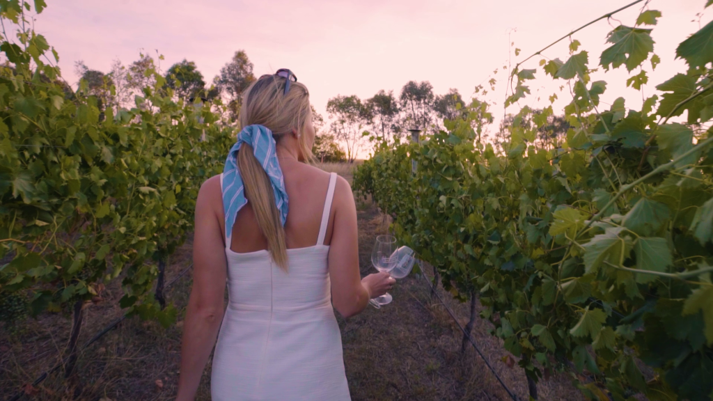 Girl walking down the aisle of Vale Creek wines